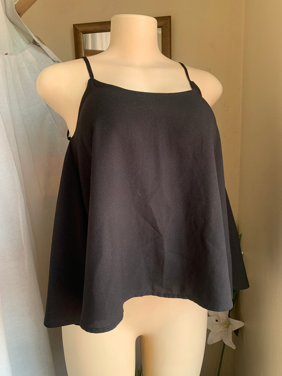 Black spaghetti tank with open back … says s