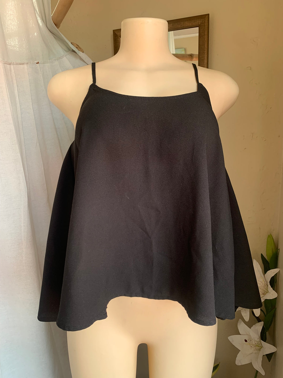 Black spaghetti tank with open back … says s