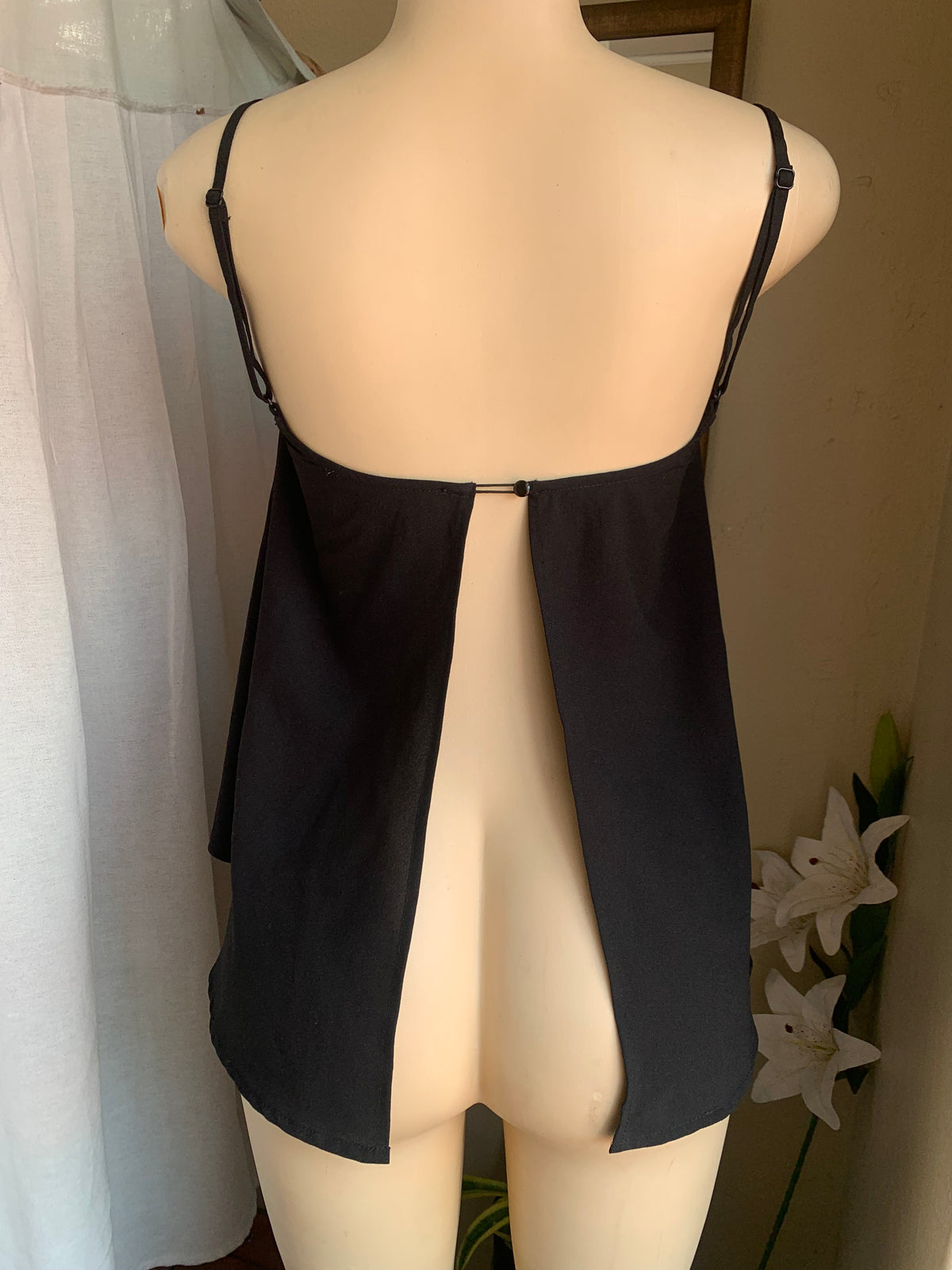Black spaghetti tank with open back … says s