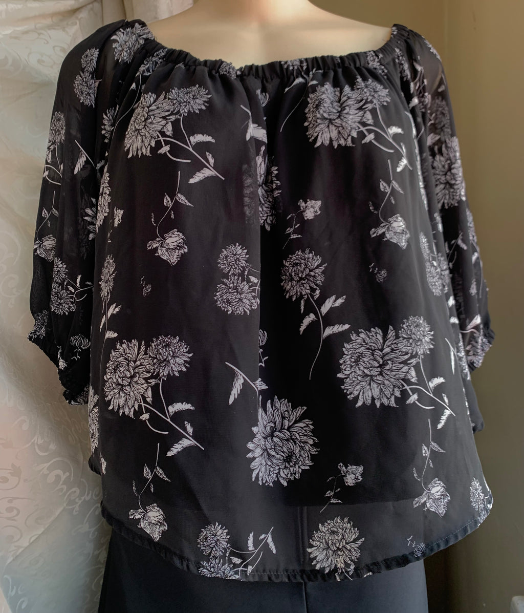 Black and white floral blouse with stretchy neckline… M