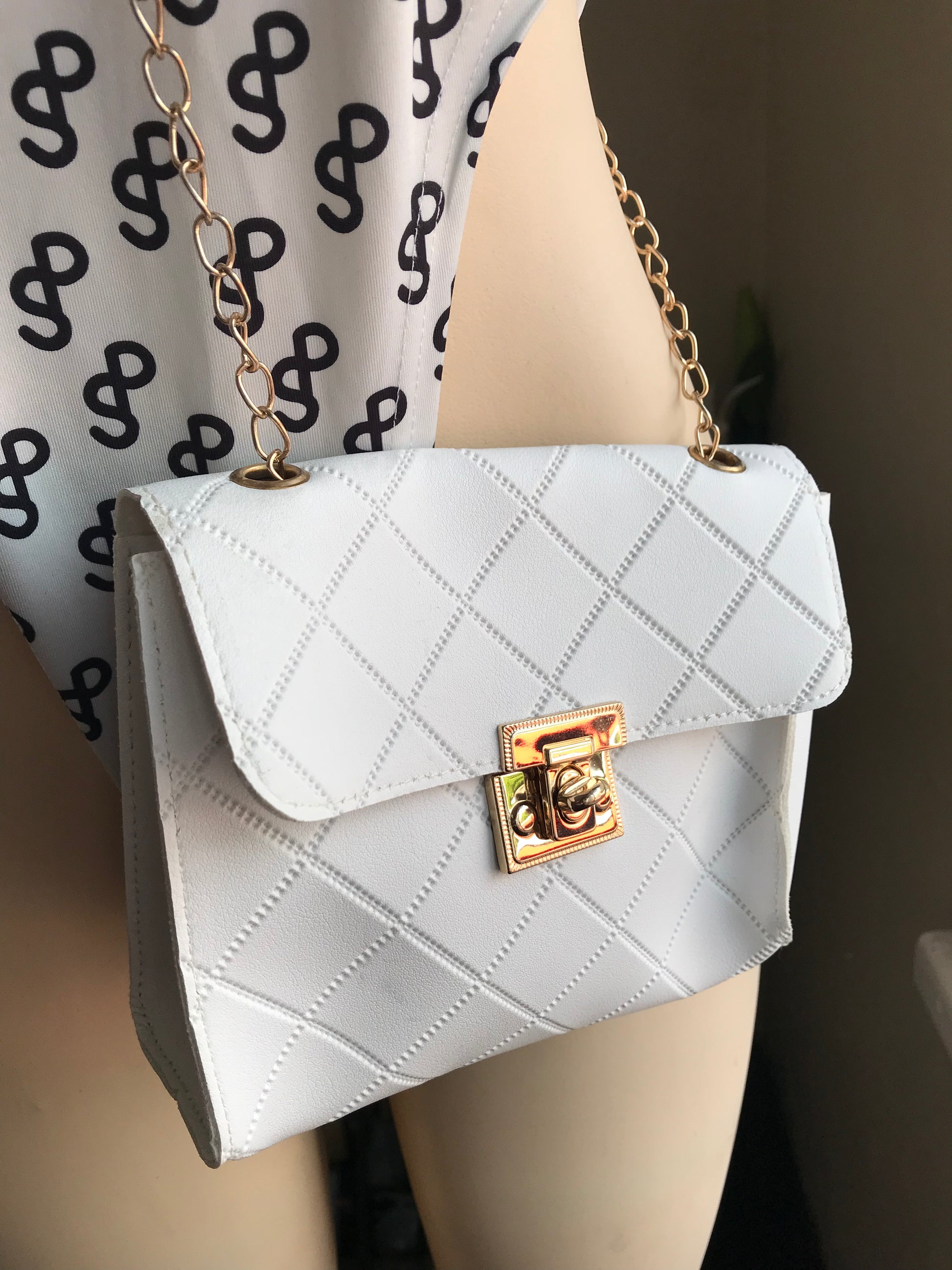 White cross hatch mini crossbody bag with gold chain