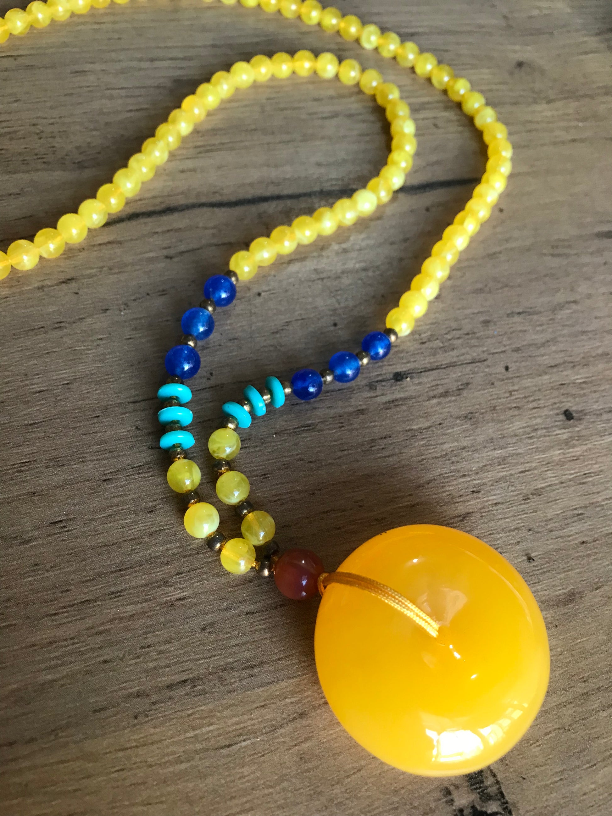 Yellow beaded necklace with pendant
